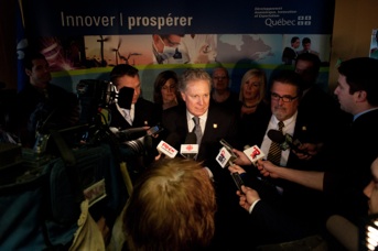 Jean Charest in scrum at Thurso factory