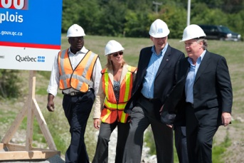 Jean Charest and Stephen Harper walking with workers