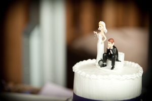 Bride and groom figurine on top of a cake