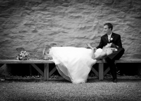 Bride and groom resting on a bench